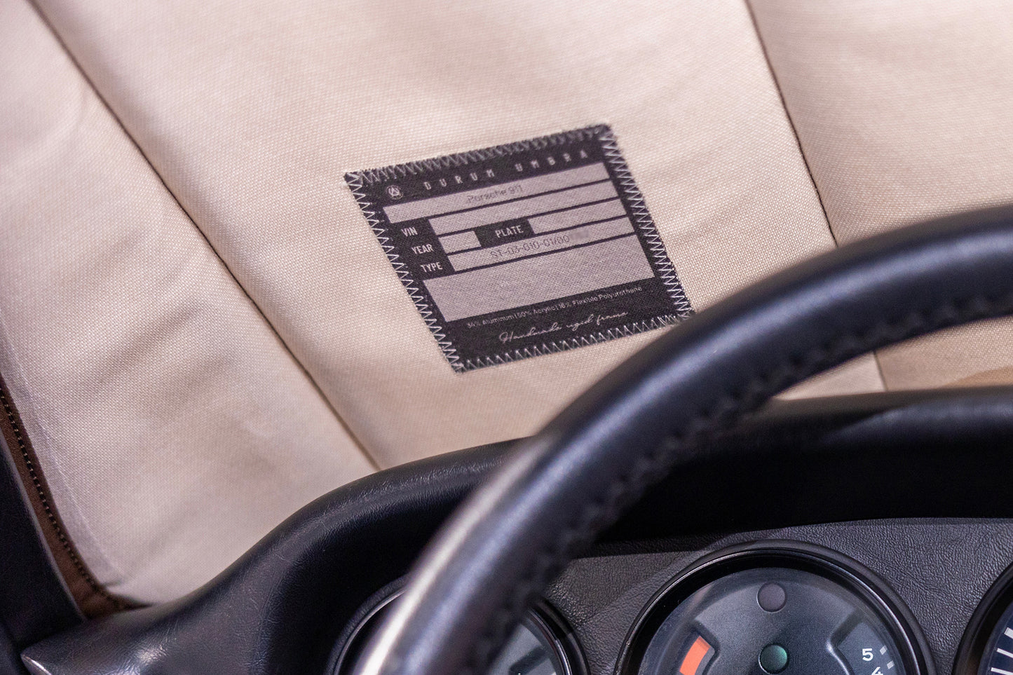 Close-up view of a custom label on a premium sunshade, showcasing a personalized design tailored for classic car enthusiasts. Autentici sun shade for car windshield.